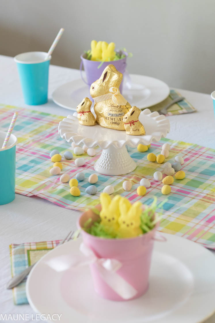 Arkansas lifestyle blogger Maune Legacy shares her Kids Easter Table Setting. Bright colors, bunny decor, festive buckets, and sweets help make this festive table setting perfect for your Easter holiday. Click here now for the full details.