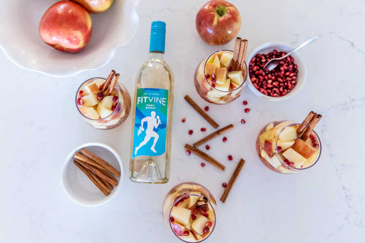 ingredients needed to make Apple Cider sangria lying on marble counter top