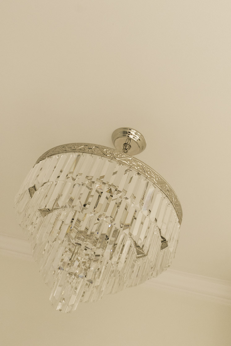 the glittering chandelier in our primary bathroom