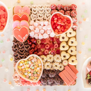 Celebrate Valentine's Day with a festive Valentines Charcuterie Board! Full of chocolates and yummy treats, this Valentine's Day Grazing Board is perfect for your Galentine's Party, date night, or valentine party.