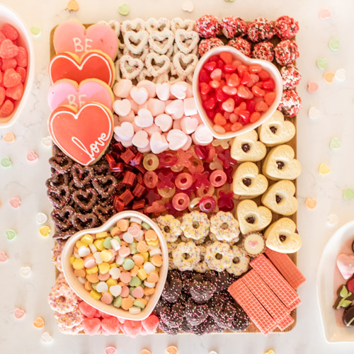 Celebrate Valentine's Day with a festive Valentines Charcuterie Board! Full of chocolates and yummy treats, this Valentine's Day Grazing Board is perfect for your Galentine's Party, date night, or valentine party.
