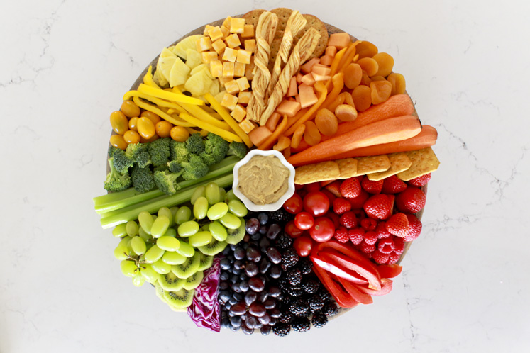 This colorful rainbow cheese board is a festive St. Patrick's Day treat or a fun rainbow snack for any day! Make this for a school party, an after school snack, or a festive gathering with loved ones or friends. You'll find a charcuterie board shopping list and tips for making your own!