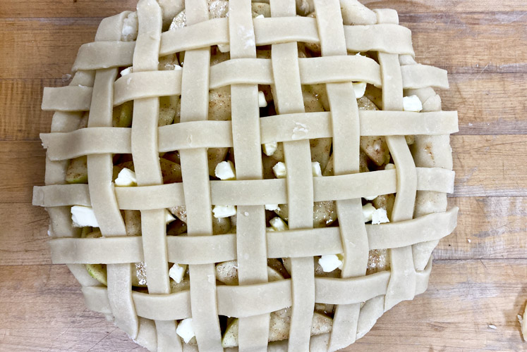 lattice crust on apple pie waiting to be baked