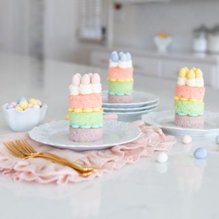 Mini Layer Cakes for Easter These Easter Mini Layer Cakes are the perfect Easter dessert! Pastel cakes layered with homemade buttercream icing make for a festive and delightful Easter layered cake. Leave the cadbury eggs off and you can serve this layered dessert any time of the year!