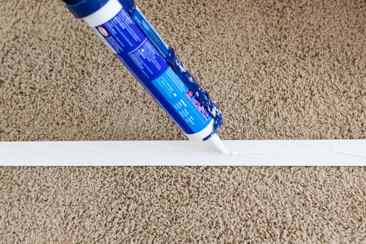 Use adhesive to install wainscoting trim.
