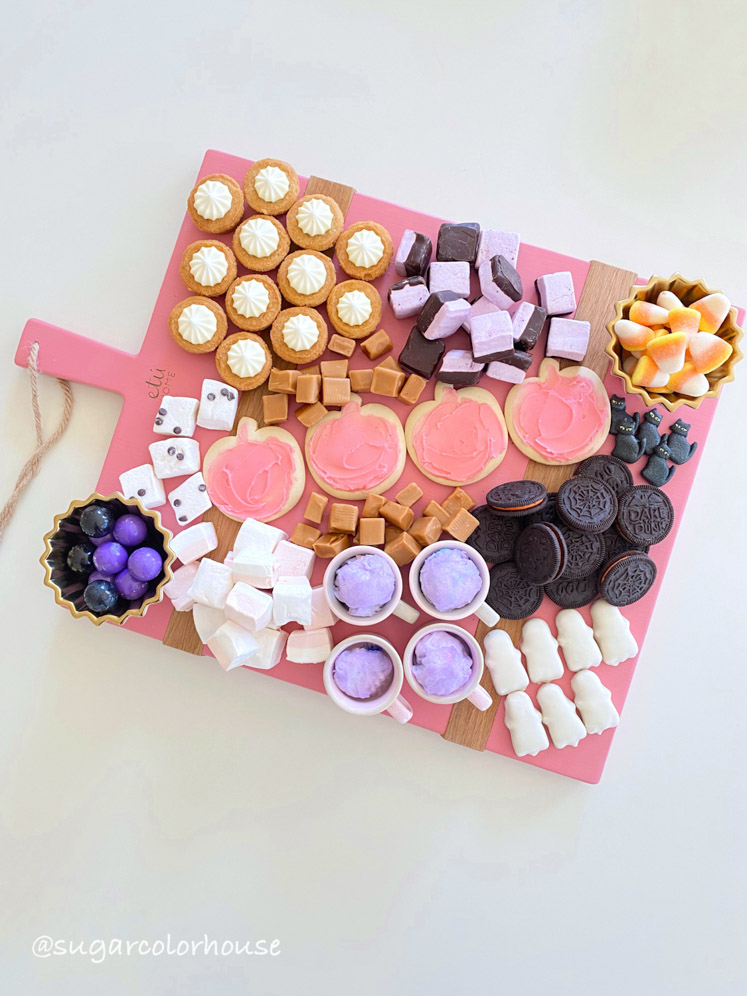 Sweets adorn this pink charcuterie board for Halloween