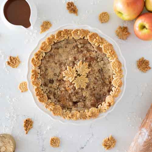This caramel apple pie recipe is a wonderful spin on your traditional apple pie. Filled with a creamy caramel sauce, cinnamon and sugar, sweet apples, and a streusel topping, this fall pie recipe will be your favorite! Also, check out the 13 Thanksgiving Menu Ideas included to give you all the fall recipe ideas.