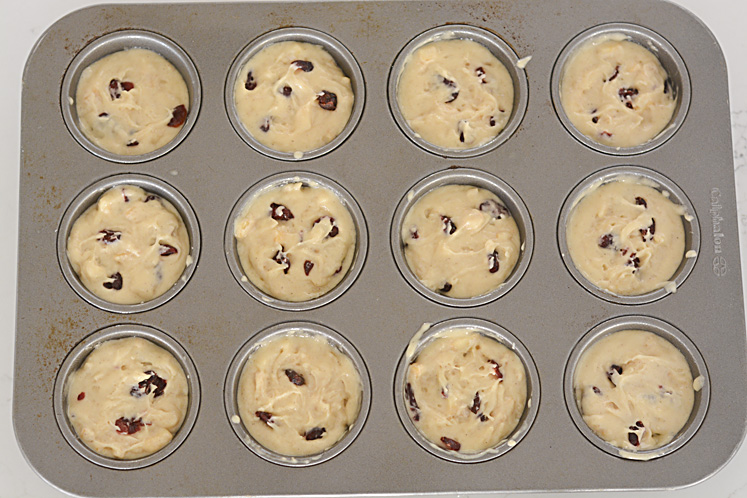 a muffin tin filled with batter and ready to pop on the oven