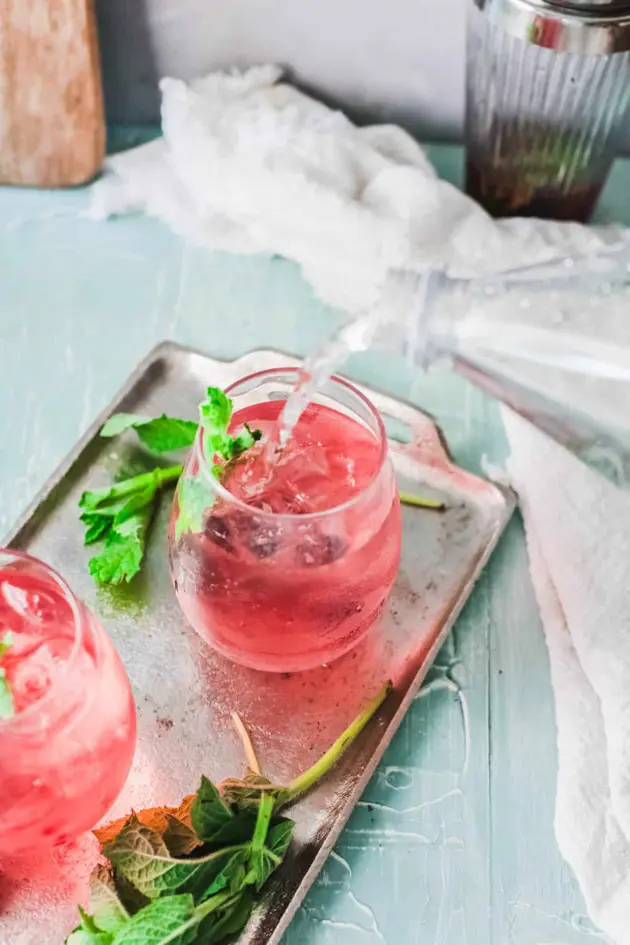 blackberry cocktail on silver tray with mint