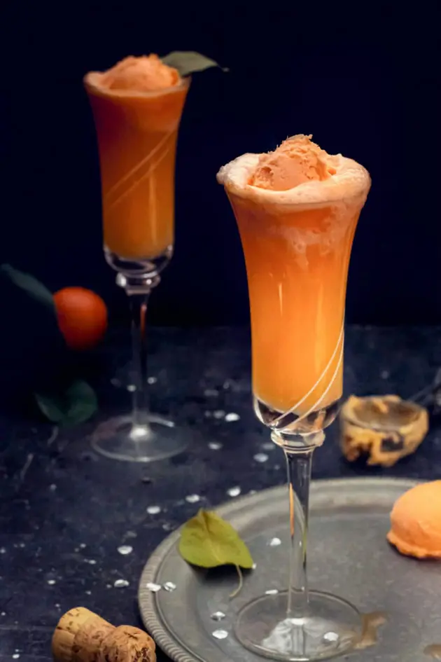 orange sherbet floating on champagne