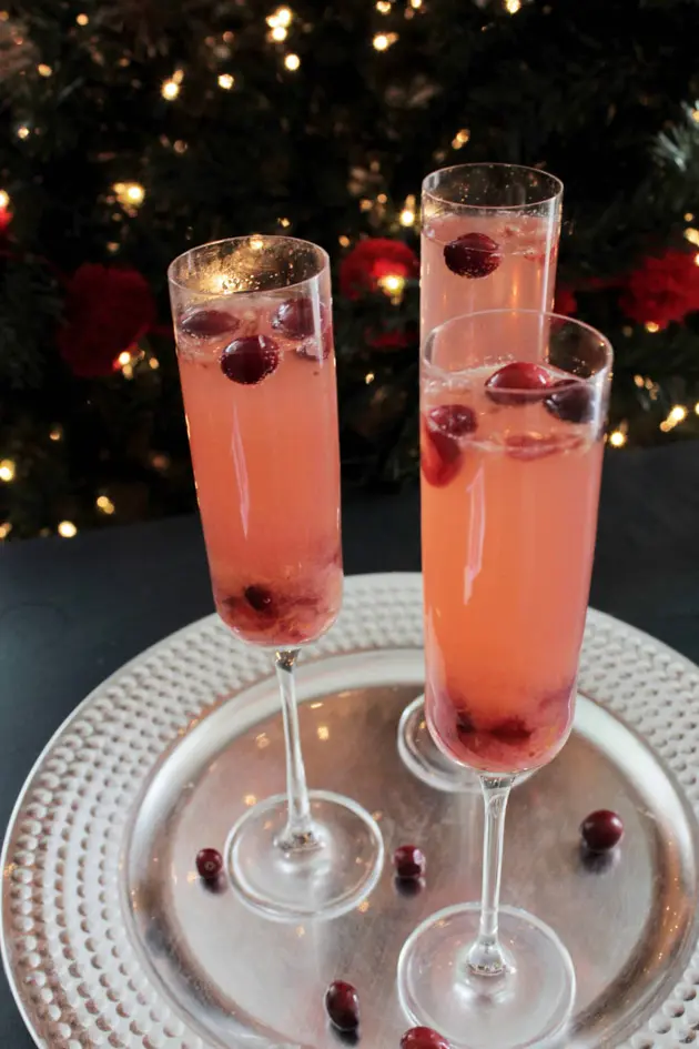 champagne and cranberry cocktail on silver tray